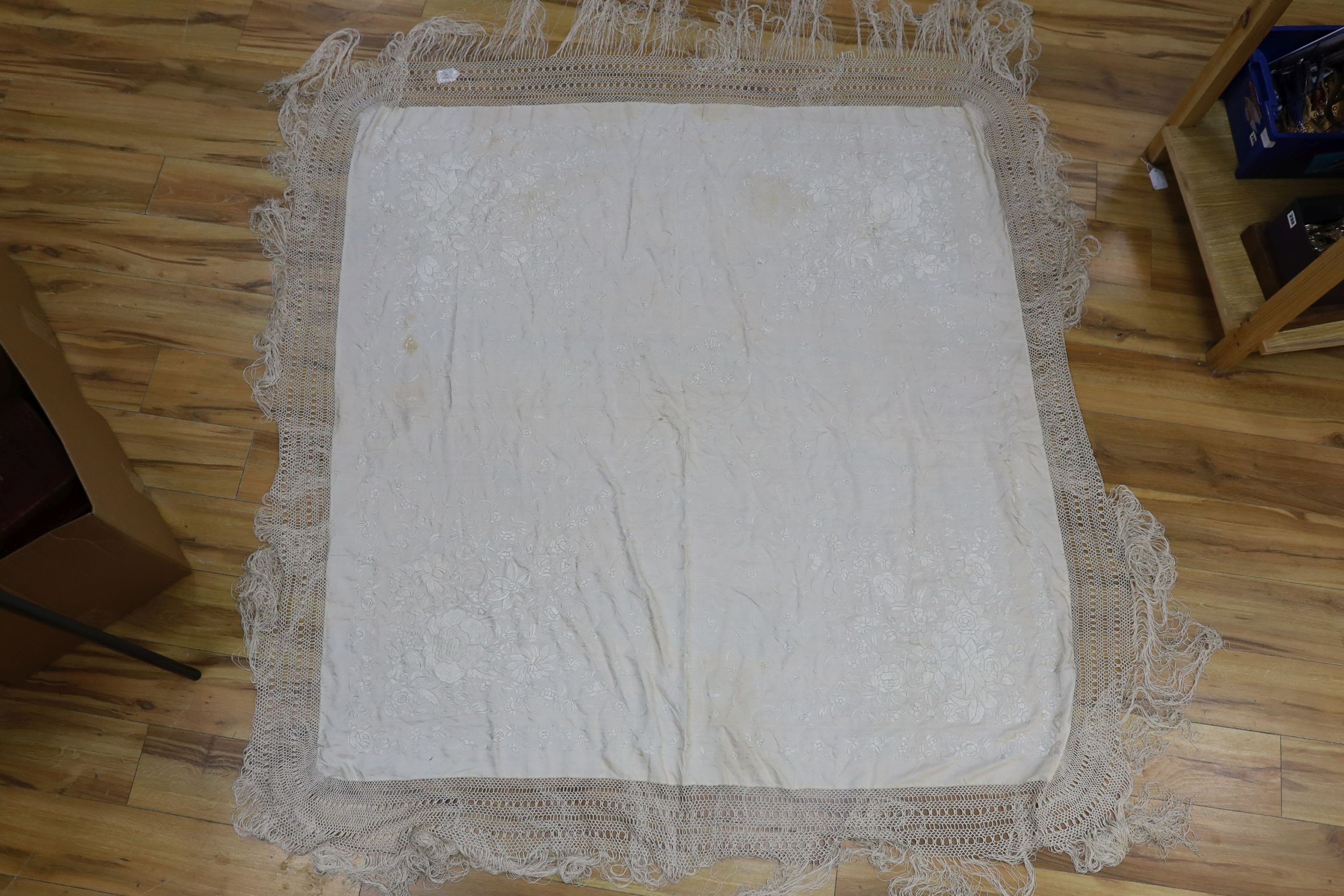 A 19th century cream embroidery on cream silk shawl together with a smaller later shawl